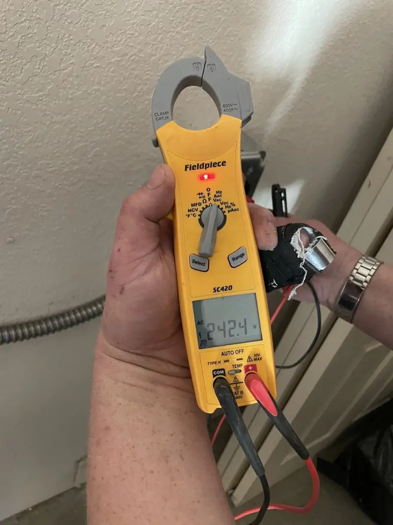Voltage testing with clamp meter during Ceiling Fan Installation in Malden